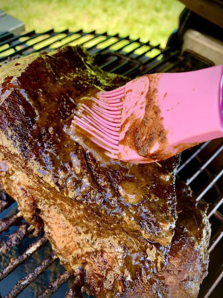 Basting the jerk pork on the kamado