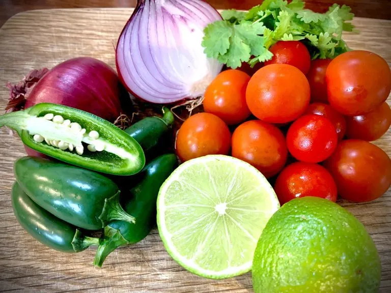 Pico de gallo ingredients: cherry tomatoes, red onion, jalapeños, limes and coriander