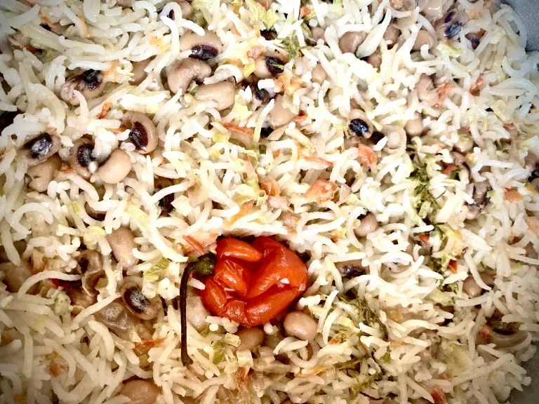 Cooked rice and peas with the whole scotch bonnet still in the pan