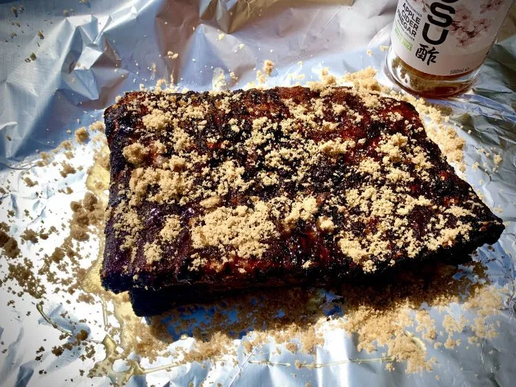 Smoked ribs on foil, sprinkled with brown sugar
