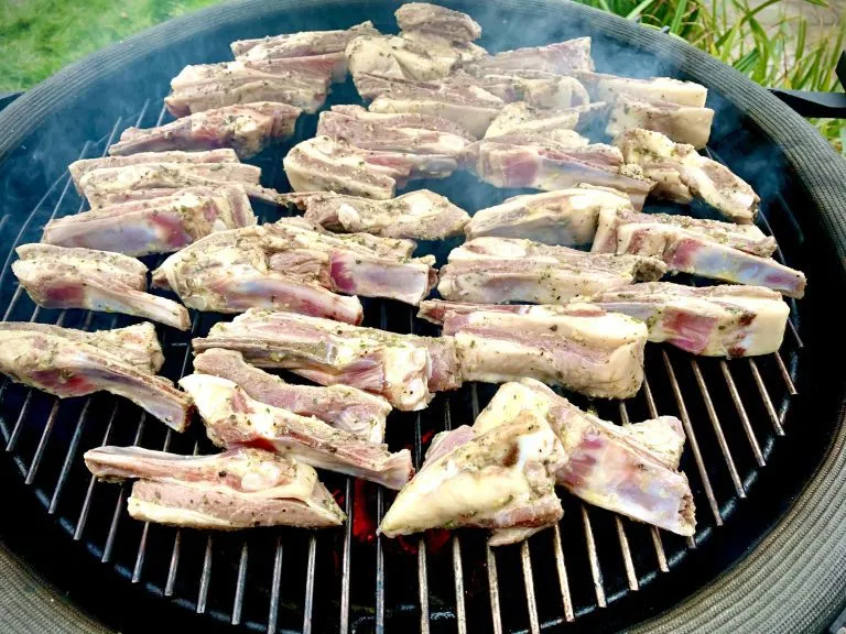 Lamb ribs on the grates directly over the coals
